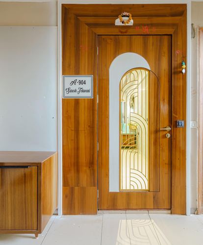Wooden front door with arched art deco glass panel, nameplate reading A-904 Suresh Tekwani