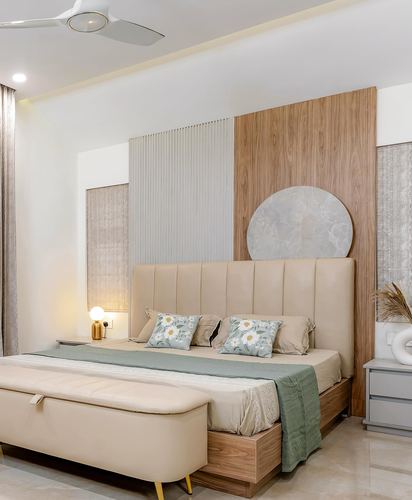 Beige bedroom with fluted panel wall, wood cladding, round stone accent, and tufted headboard