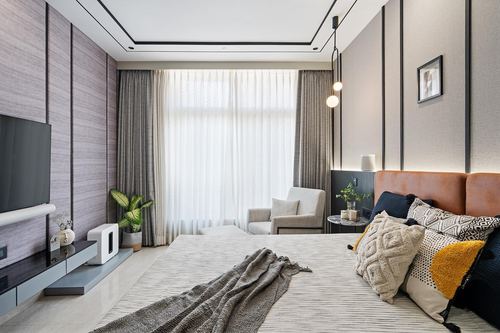 Modern bedroom with tan leather headboard, ribbed wood-panel walls, and sheer-curtained window