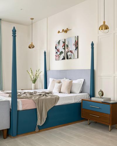 Teal four-poster bed with grey headboard, wood nightstand, brass pendants and floral wall art