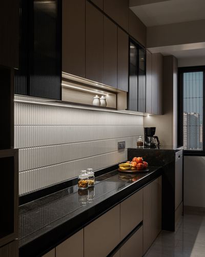 Galley kitchen with fluted cabinetry, ribbed backsplash, dark stone countertop and city view window
