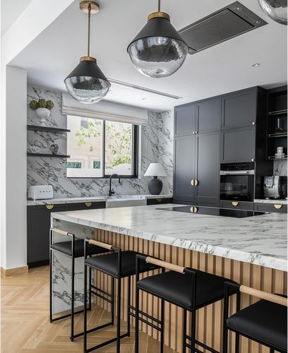 Black and white kitchen with marble backsplash, fluted wood island, and black bar stools