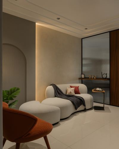 Curved beige sofa with rust cushions beside a glowing ribbed niche in a warm minimalist living room