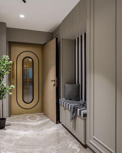 Entryway with striped bench, fluted paneling, and an oval gold-framed mirrored door