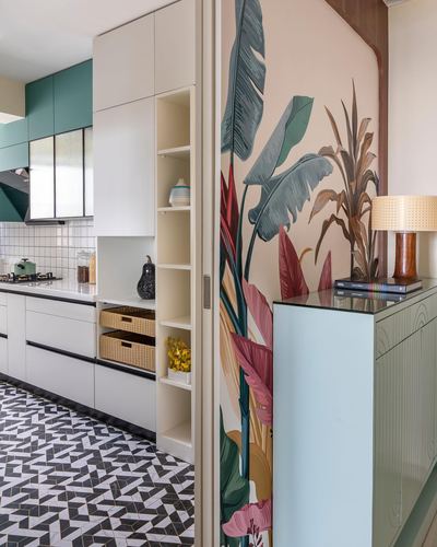 Kitchen with teal cabinets and geometric floor beside a tropical mural sliding panel and green console
