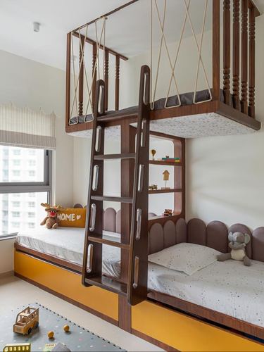 Children's bunk bedroom with wooden loft bed, ladder, and twin beds with scalloped headboards