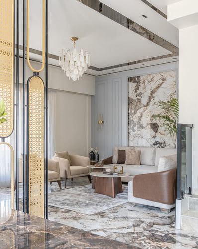 Living room with marble feature wall, sectional sofa, brass details and cane screen divider