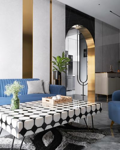 Living room with blue velvet sofa, geometric marble coffee table, and gold-framed arched mirror doorway