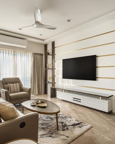 Living room with marble floor, gold-striped tv wall, and beige recliner seating