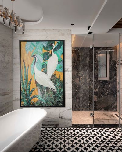 Marble bathroom with clawfoot tub, crane artwork, patterned floor and dark stone shower