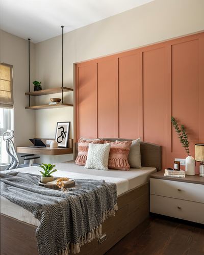 Bedroom with terracotta fluted panel headboard wall, wooden bed, and floating study nook