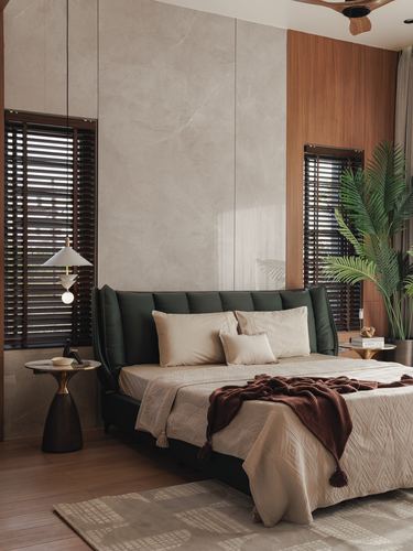 Bedroom with green tufted headboard, stone wall panel, wooden blinds, and pendant lights over side tables