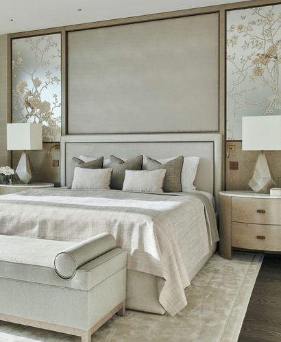 Neutral master bedroom with upholstered headboard, chinoiserie side panels, and faceted table lamps on round nightstands