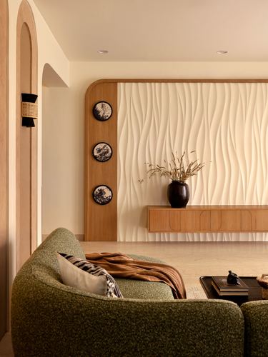 Living room with fluted wall panel, floating wood console, and green boucle sofa