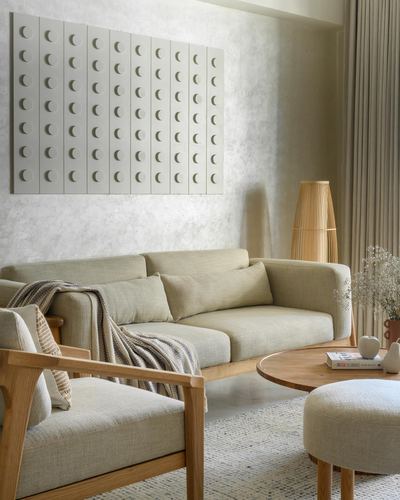 Beige living room with textured wall panel, oak-framed sofa and rattan floor lamp