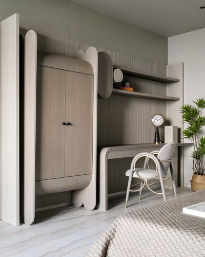 Bedroom wardrobe with scalloped wood panels beside desk and open shelving on fluted wall