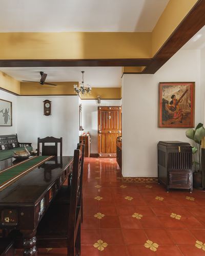Traditional Indian dining room with dark wood furniture and patterned Athangudi tile flooring