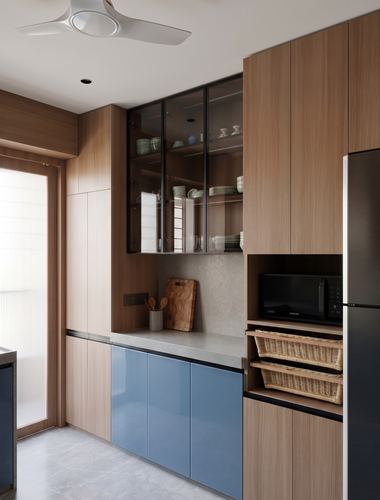 Wood-panelled kitchen with glass cabinets, blue gloss base units, and built-in microwave nook