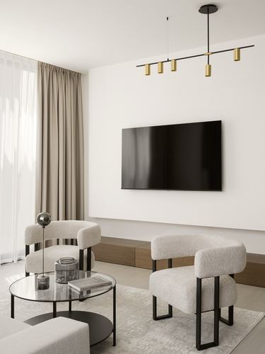 Minimalist living room with boucle armchairs, glass coffee table and wall-mounted TV under a linear pendant