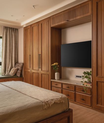 Wooden bedroom wall unit with wardrobe, tv niche, drawers, and window seat with cushions