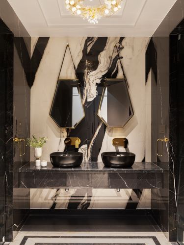 Double vanity bathroom with black marble counter, dark vessel sinks, hexagonal brass mirrors on veined marble wall