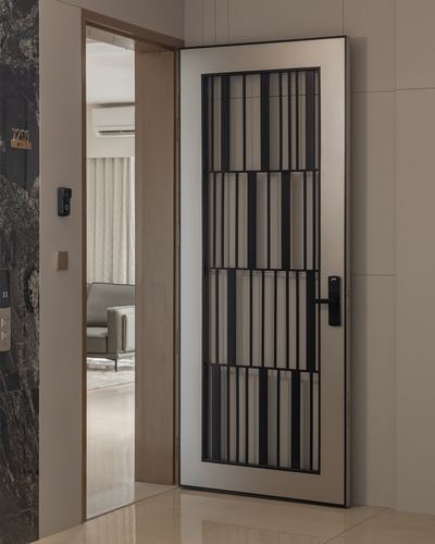 Open black-grilled security door in a marble-clad foyer with glimpse into living room