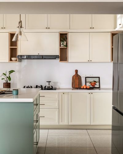 Cream shaker kitchen with sage green island and glass cone pendant lights