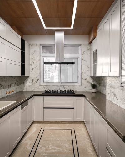 White U-shaped kitchen with marble backsplash, dark countertop, and wood ceiling panel over cooktop