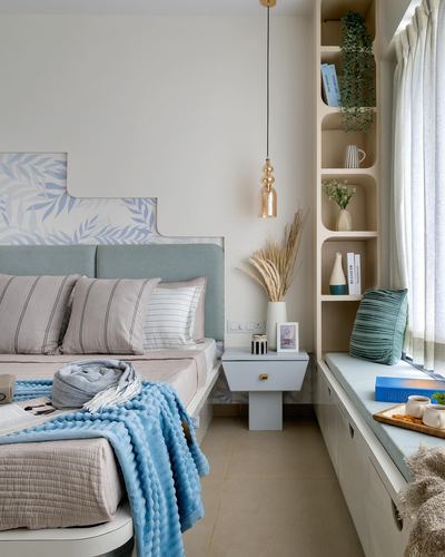 Pastel bedroom with mint headboard, blue accents, corner shelving and cushioned window seat