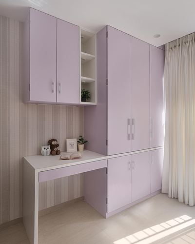 Lilac wardrobe and built-in study desk with open display niche in a pastel bedroom corner