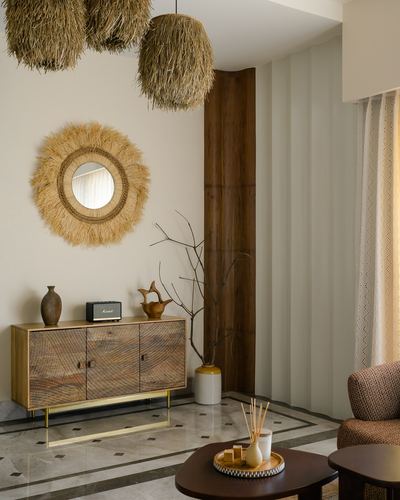 Foyer with patterned wood sideboard, sunburst mirror, and jute pendant lights over marble floor