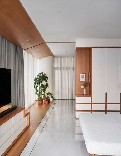 Bedroom with curved wood ceiling, sheer curtains, marble floor, and wood-white wardrobe