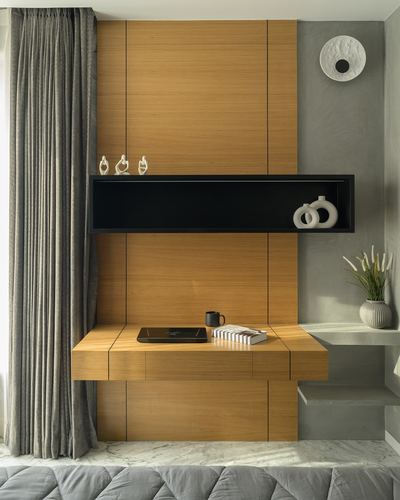 Floating wood console with black recessed niche and sculptural vases against textured grey wall