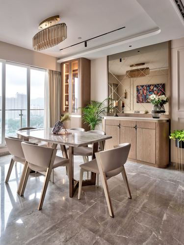 Dining room with marble-top table, cane-back chairs, and mirrored wall behind a wood console