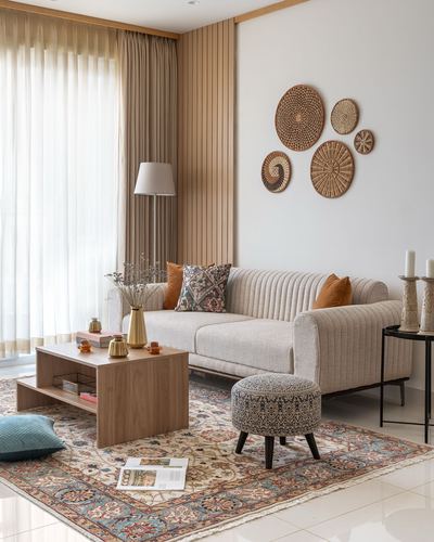 Beige living room with ribbed sofa, patterned rug, and woven basket wall art
