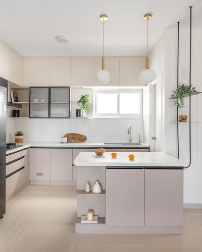 Bright beige minimalist kitchen with island counter and two globe pendant lights