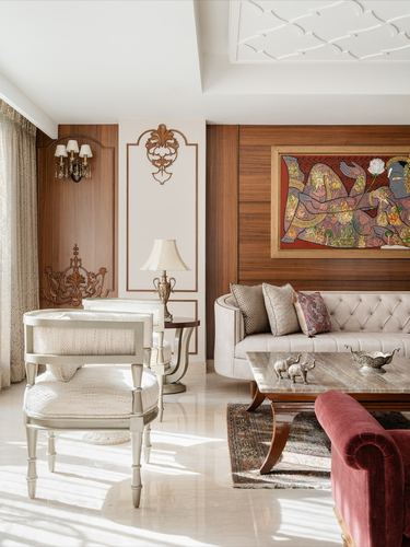 Living room with tufted cream sofa, traditional painting on wood panel, marble coffee table