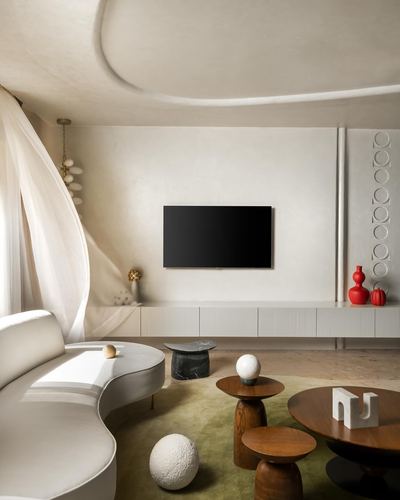 Curved white sofa faces wall-mounted TV above ribbed console in minimalist living room