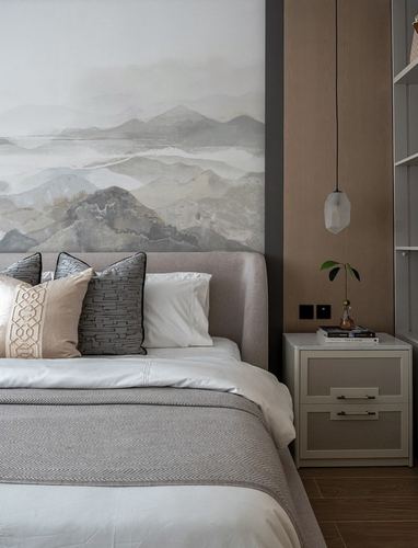 Bed with upholstered headboard beneath a grey mountain mural, nightstand and pendant light beside it