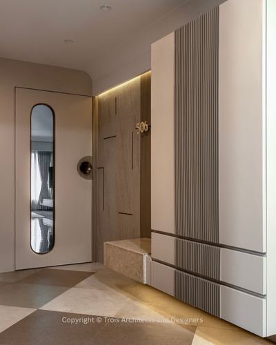 Entryway with mirrored door, fluted panel wall, unit number 506, and checkered stone floor