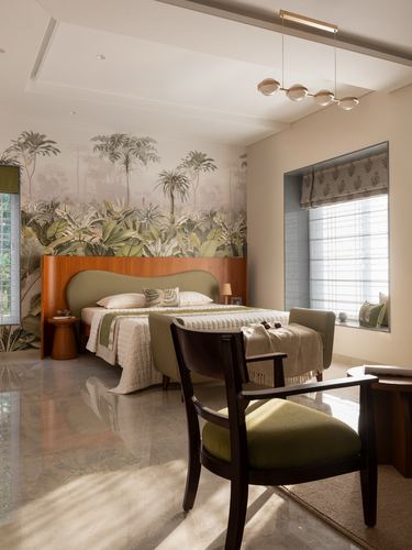 Bedroom with tropical mural wall, curved green headboard, marble floor and window seat