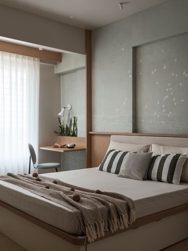 Bedroom with sage textured wall, bird motif panel, wooden bed and study nook by window