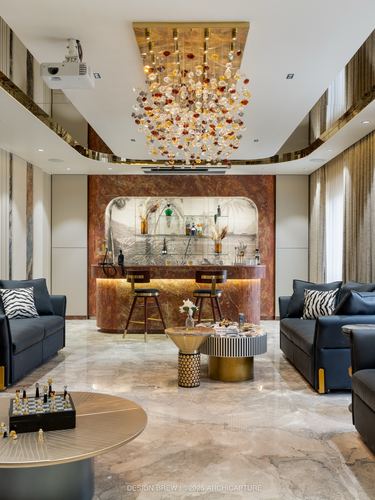 Luxury living room with backlit stone bar niche, crystal chandelier, and black leather sofas on marble floor