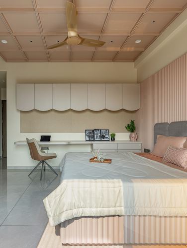 Pink-toned bedroom with scalloped storage, built-in desk, and houndstooth headboard bed