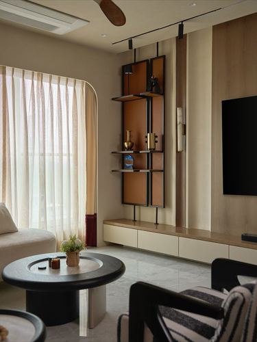 Living room with hanging display shelf, marble floor, curved sofa and wall-mounted tv