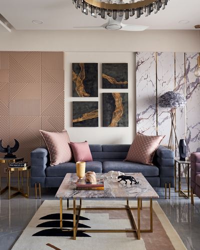 Living room with grey sofa, marble-top coffee table, gallery wall art, and pink geometric wall panel