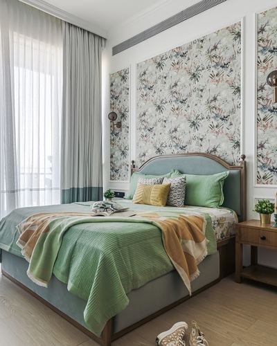 Bedroom with green upholstered bed, floral wallpaper panels, and sheer curtains by window
