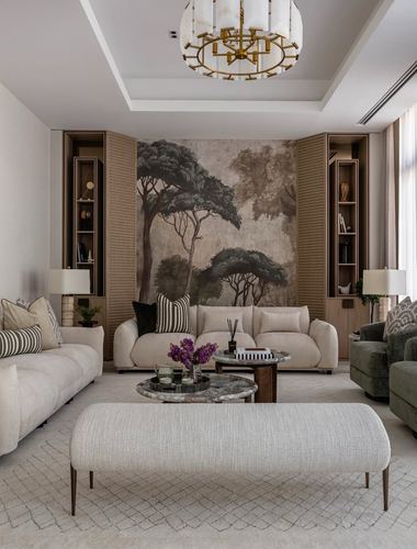 Neutral living room with tree mural, ribbed wood shelving, and layered marble coffee tables