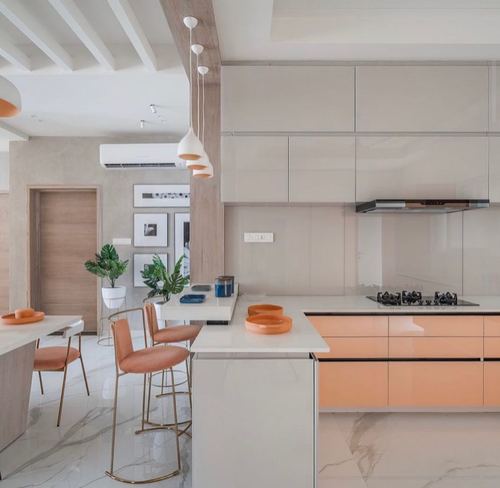 Modern kitchen with peach glossy cabinetry, grey uppers, marble floor, and cluster pendant lights over island