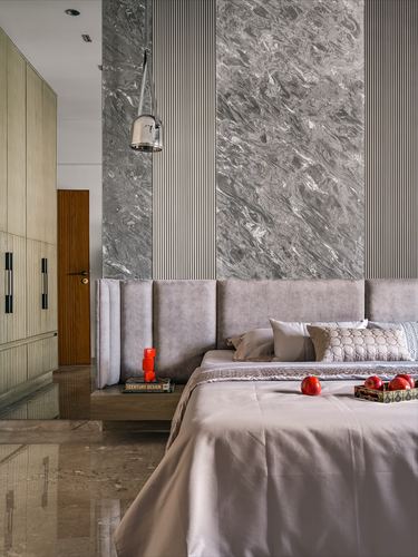 Bedroom with marble feature wall, fluted panels, upholstered headboard and pendant light
